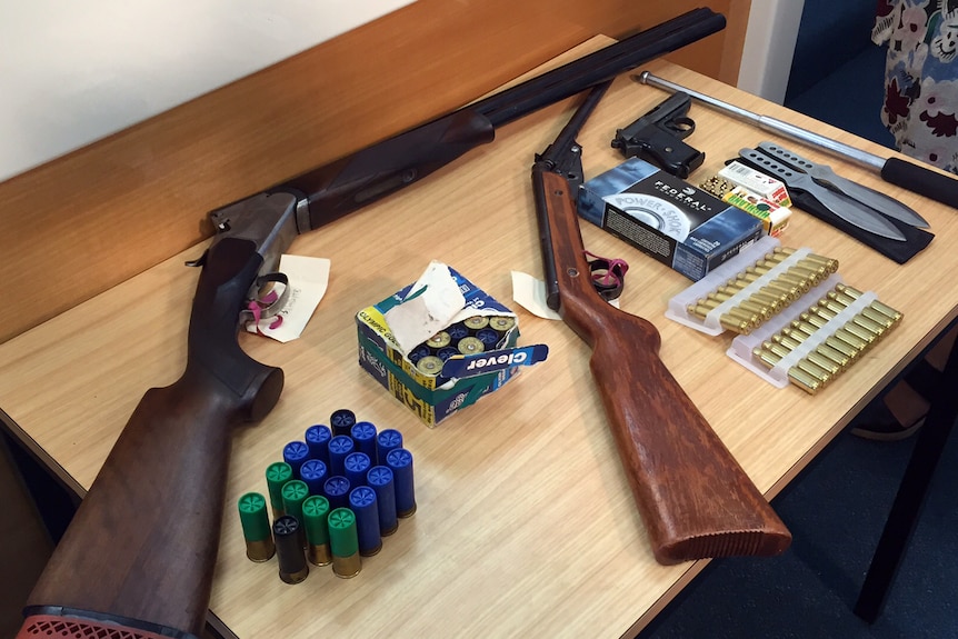 The police raid allegedly netted two 12-gauge shotguns, a semi-automatic pistol, ammunition and throwing knives.