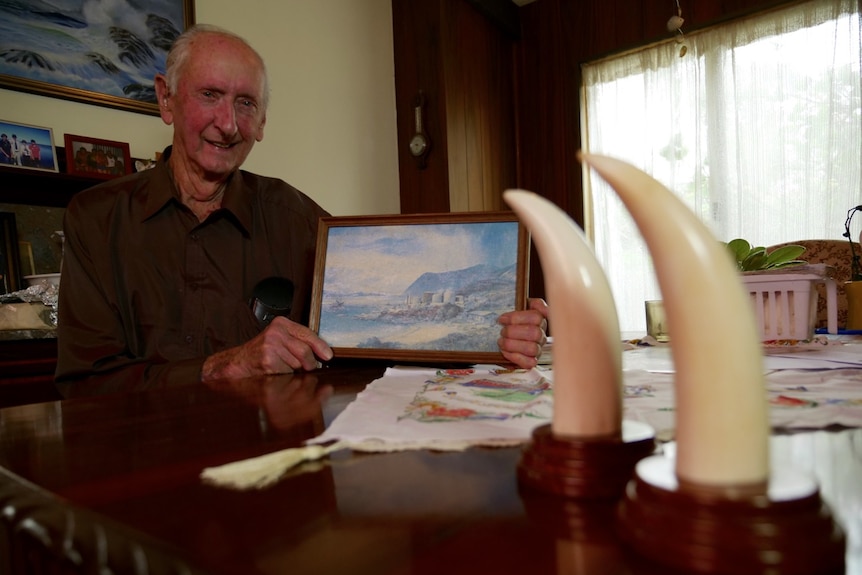 Former whaling station transporter John Rowe at home with ornamental whale teeth