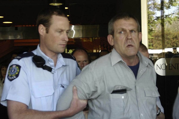 A November 10, 2003 file photo of Bradley John Murdoch being arrested by police at Adelaide's Sir Samuel Way court building