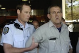 A November 10, 2003 file photo of Bradley John Murdoch being arrested by police at Adelaide's Sir Samuel Way court building