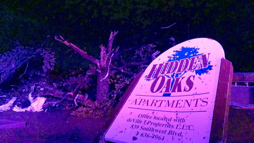 The sign for the Hidden Oaks apartment complex in Jefferson City Missouri stands bent by the tornado.