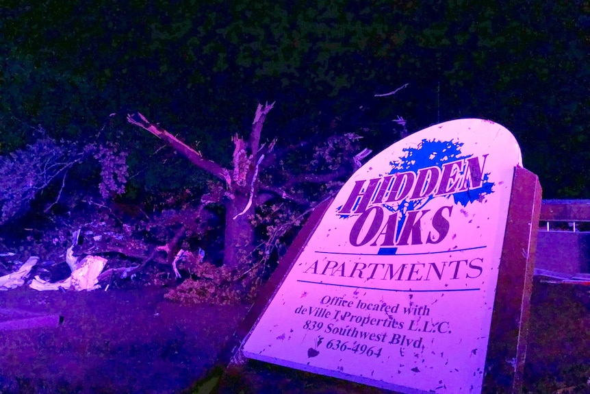 The sign for the Hidden Oaks apartment complex in Jefferson City Missouri stands bent by the tornado.