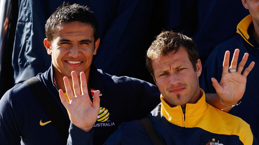 Tim Cahill and Lucas Neill wave to fans