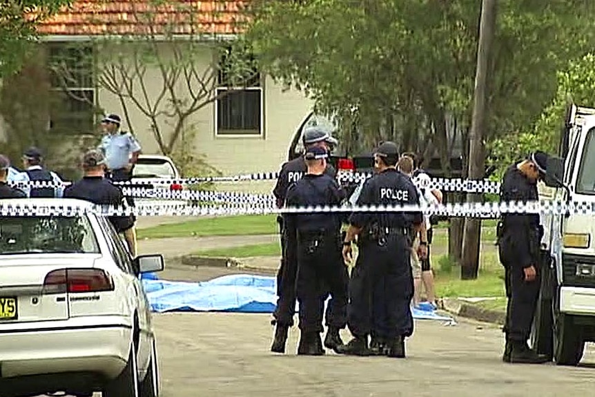 Police gather outside a house in Punchbowl after a double shooting.