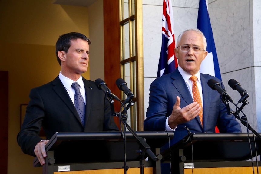 French Prime Minister Manuel Valls and Australian Prime Minister Malcolm Turnbull stand at podiums in Canberra.