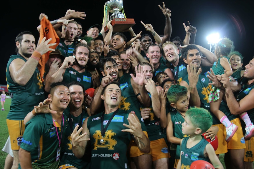 Group shot of the St Marys football team celebrating with the premiership cup after the 2017 grand final.