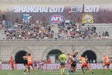 Gold Coast Suns and Port Adelaide Power play in front of a sign saying Shanghai 2017.