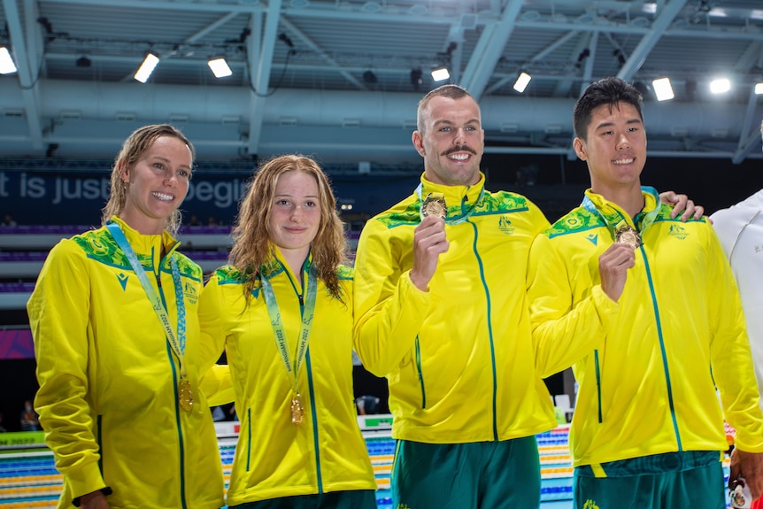 A group of swimmers with their medals