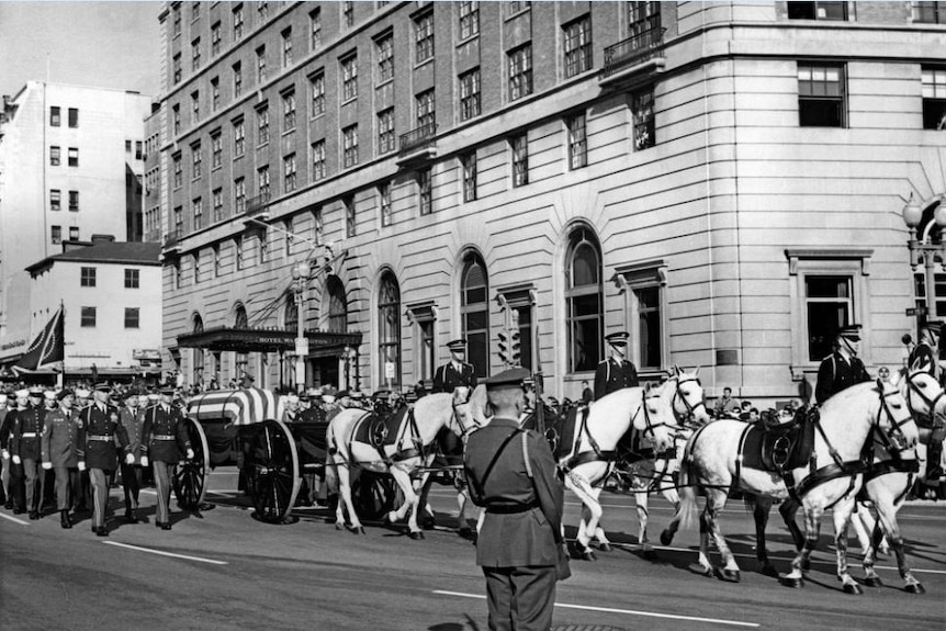 John F Kennedy's casket carried by a horse-drawn carriage