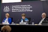 Three commissioners at a high table: Professor Leah Bromfield, Marcia Neave AO and Robert Benjamin AM.