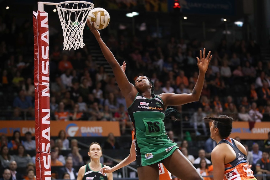 Jhaniele Fowler stretches her arm high to catch a pass during a match against the Giants.