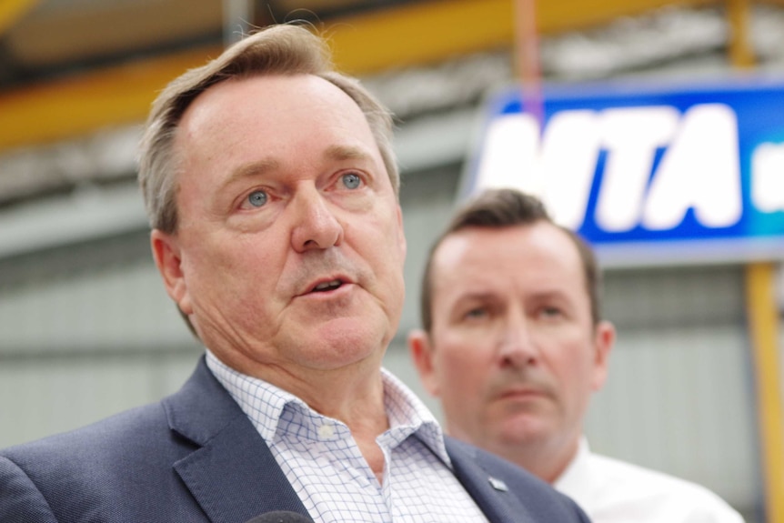 A man from the Motor Trades Association speaking, with another man behind him