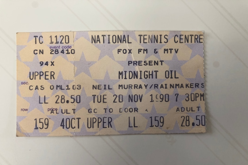 A photo of an original ticket stub from a 1990 Midnight Oil concert at the National Tennis Centre in Melbourne.