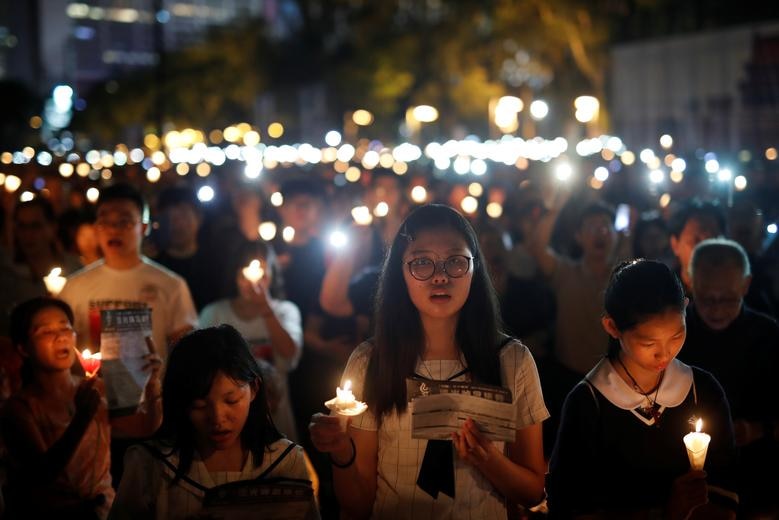 People holding candles at a vigil in HK for the 30th anniversary of the Tiananmen Square massacre