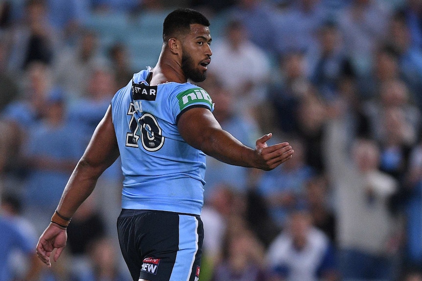 NSW Blues player Payne Haas gestures behind him as he walks off the field.