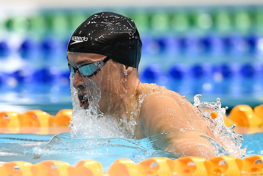 A swimmer mid-stroke during a race