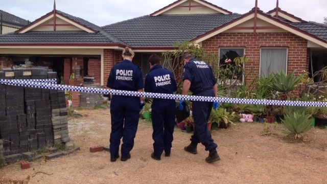 Police officers inspect a Clarkson property