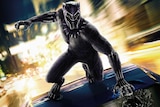 Colour still image of superhero character Black Panther on top of a moving vehicle, the still is from the movie poster.