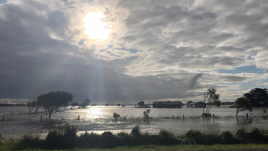 A farmhouse is surrounded by floodwater as the sub breaks through the clouds.