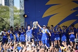 Eagles coach Adam Simpson and captain Shannon Hurn present the cup to the crowd.