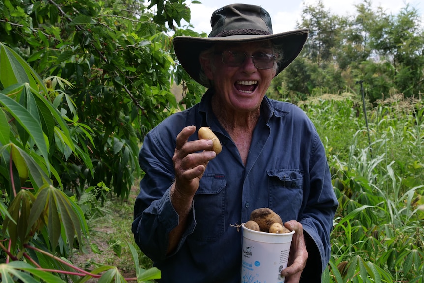 A man holding a potato.