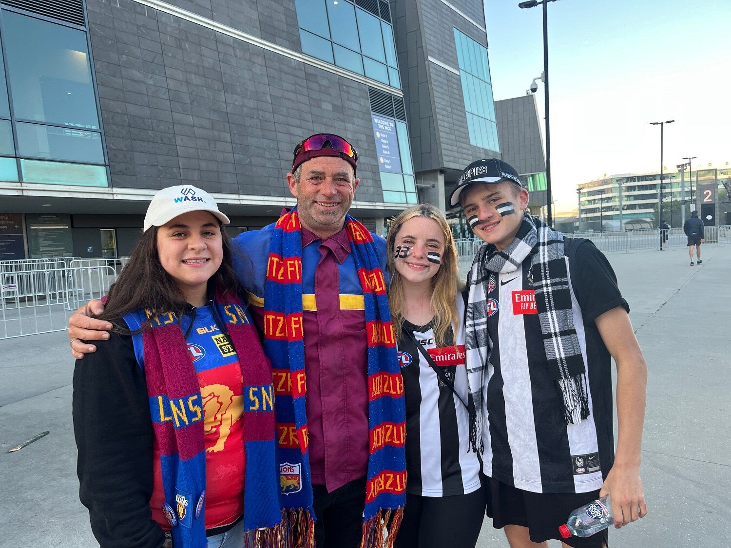 Daniel Kilfoy smiles, flanked by his three children.