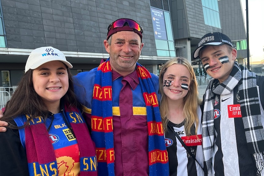 Daniel Kilfoy smiles, flanked by his three children.