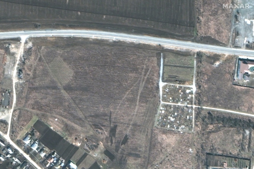 A handful of graves have been dug at the end of an existing cemetery. 