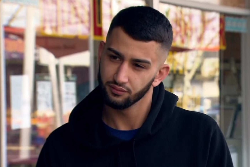 A man in a black top with a beard.