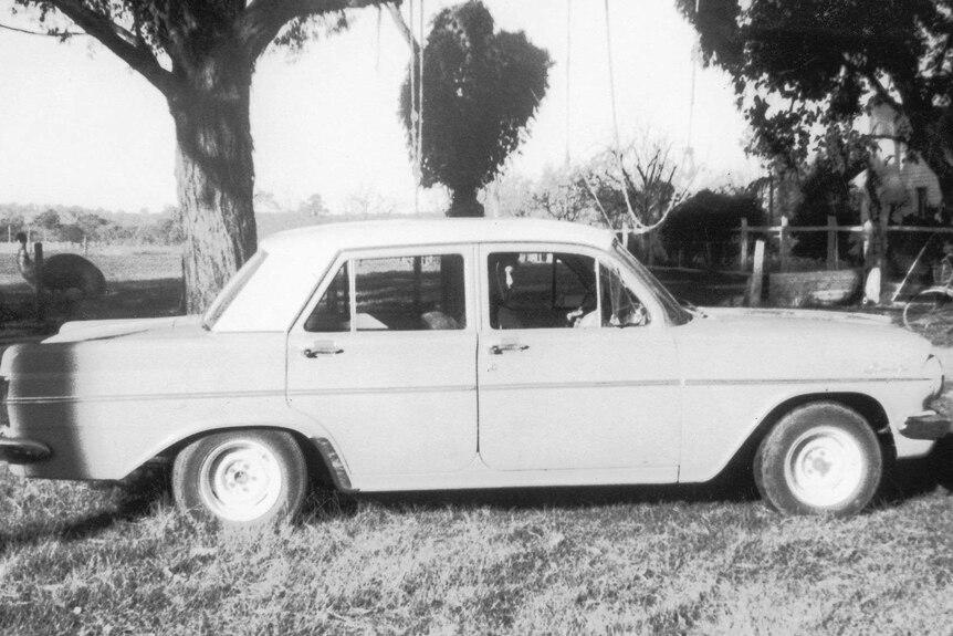 Pepe standing behind Holden car. Photo take in the 60s, black and white photo