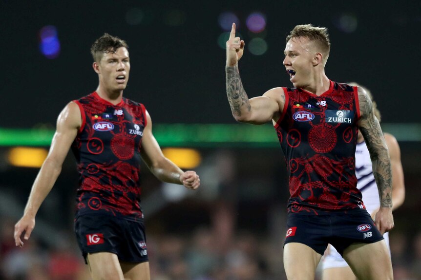 James Harmes points his finger as he celebrates a Demons goal against the Dockers.