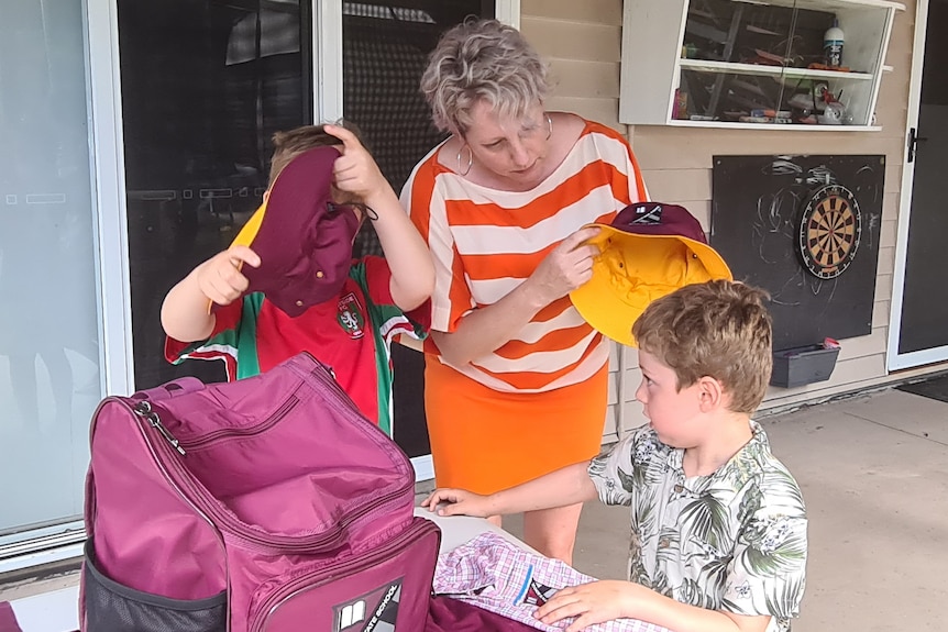 A mother puts a hat on a child's head