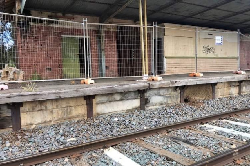 Disused and vandalised brick railway station 