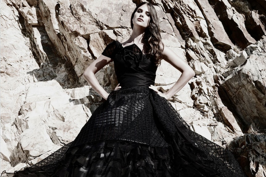 Model wearing Hajar's black gown with flluted skirt