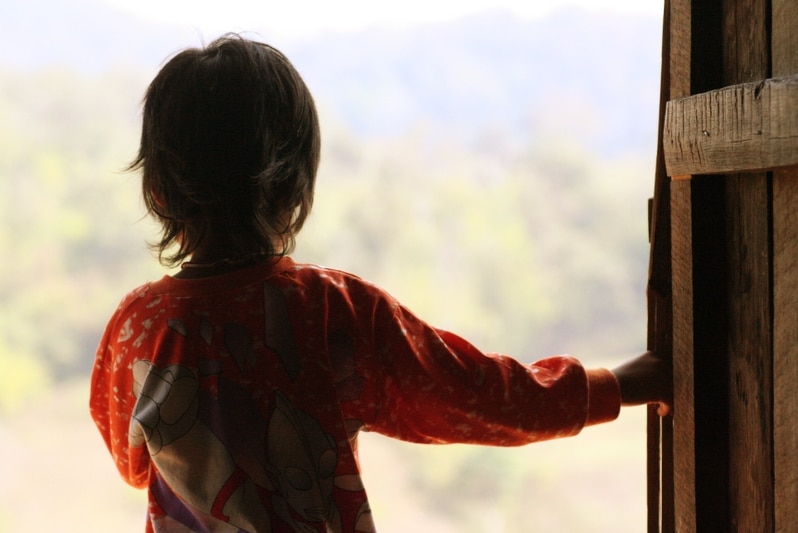 A boy facing away from the camera.