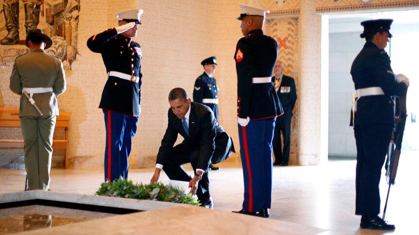 US President Barack Obama lays a wreath at the Tomb of the Unknown Soldier.