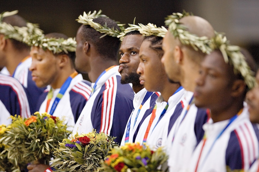 LeBron James purses his lips alongside Team USA teammates while getting bronze basketball medals at the 2004 Athens Olympics.