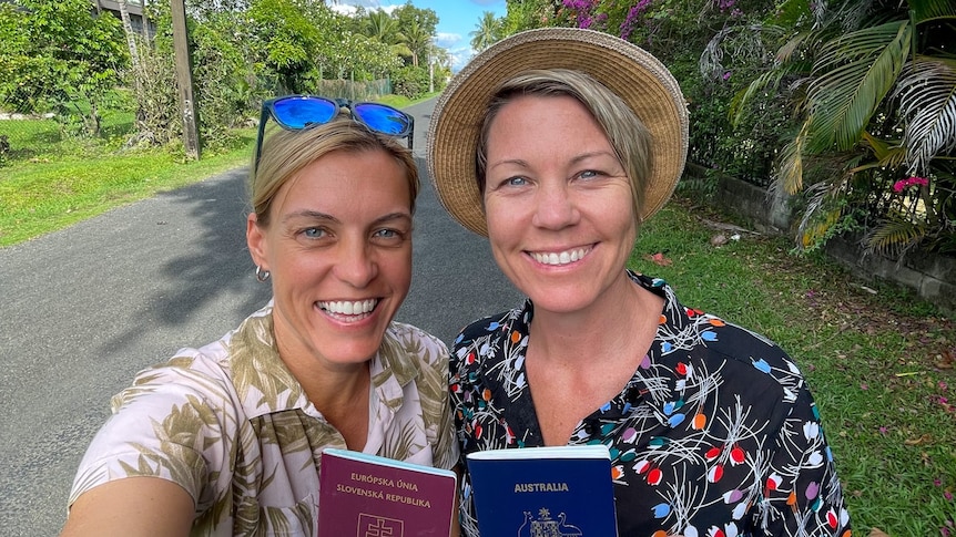 Two women smiling with passports and looking happy on holidays 