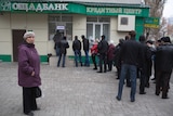 Ukrainians line up to withdraw money from a bank in Donetsk