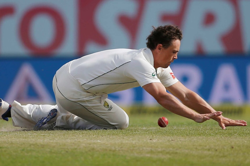 Australia's Steve O'Keefe struggles to stop a ball in the field on day four in Dharamsala.
