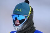 An Australian male cross-country skier with ice forming on the chin of his uniform.