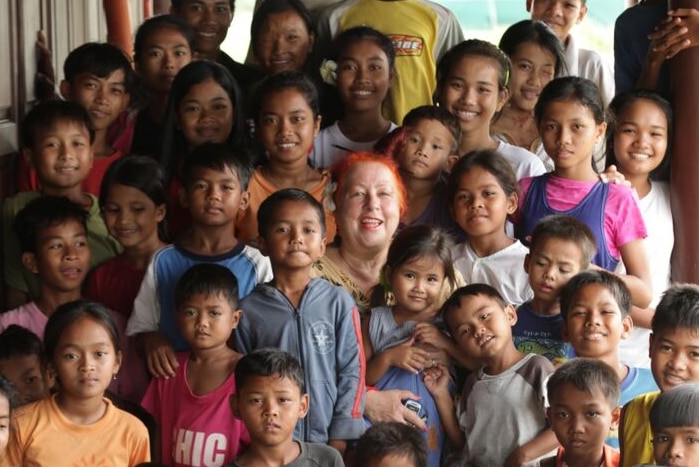 Geraldine Cox surrounded by children at an orphanage