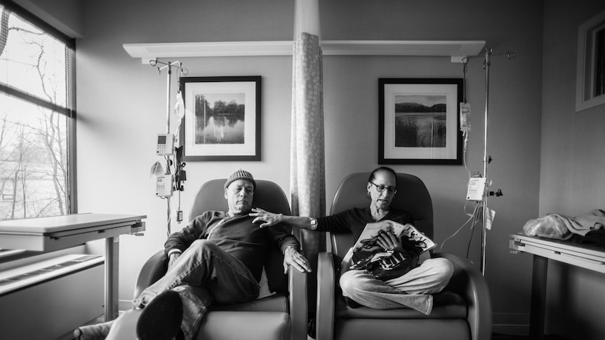 Howie and Laurel Borowick sitting together in a treatment room, both having chemo.
