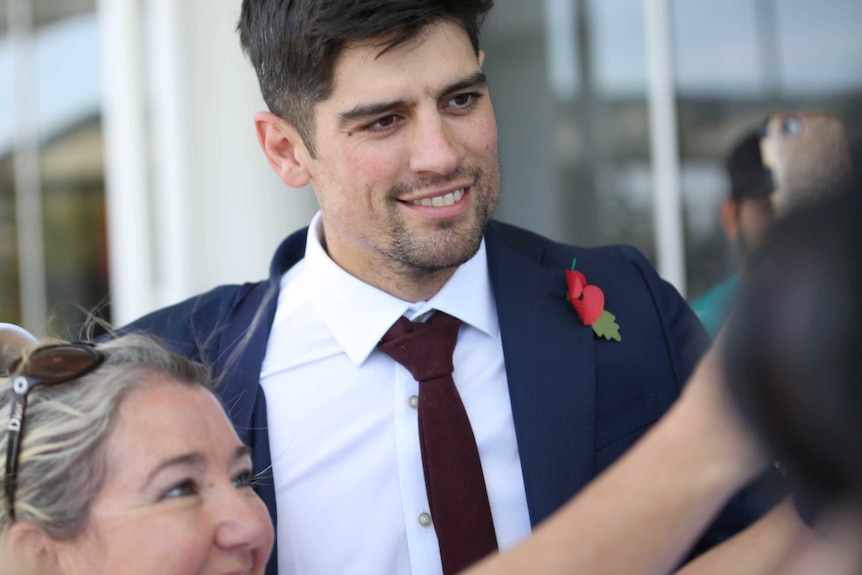English cricketer Alastair Cook with a fan taking a selfie at Perth Airport.