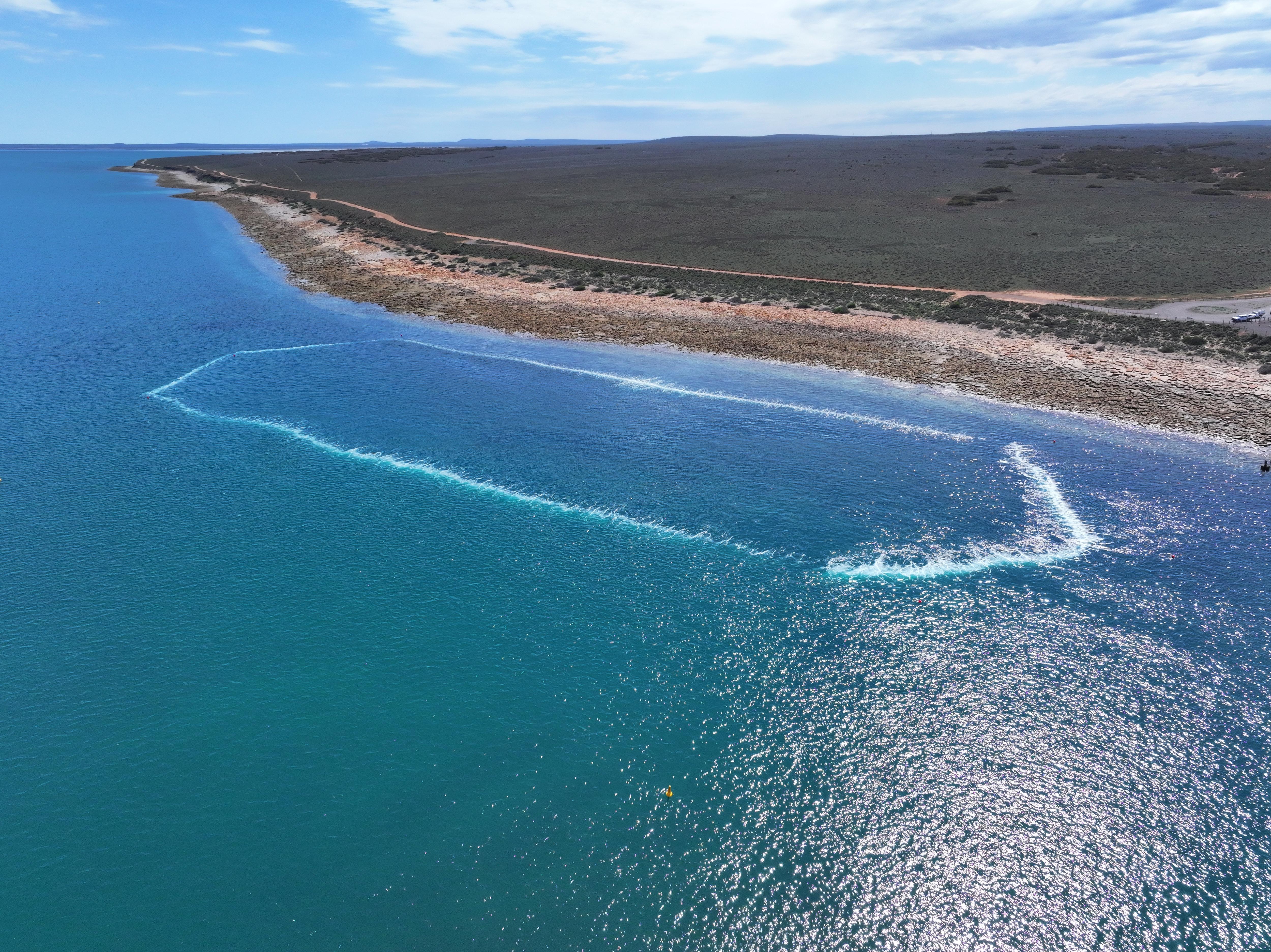 Aerial view of the bubble curtain showing an area of ocean with a white bubble ring