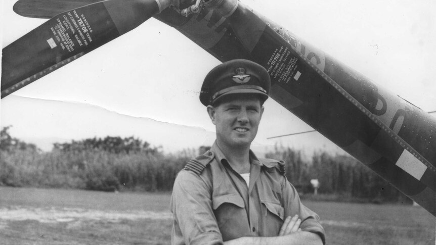 Pilot Jim Reilly standing in front of the tail rotor of a helicopter while serving with the RAF in Malaysia.