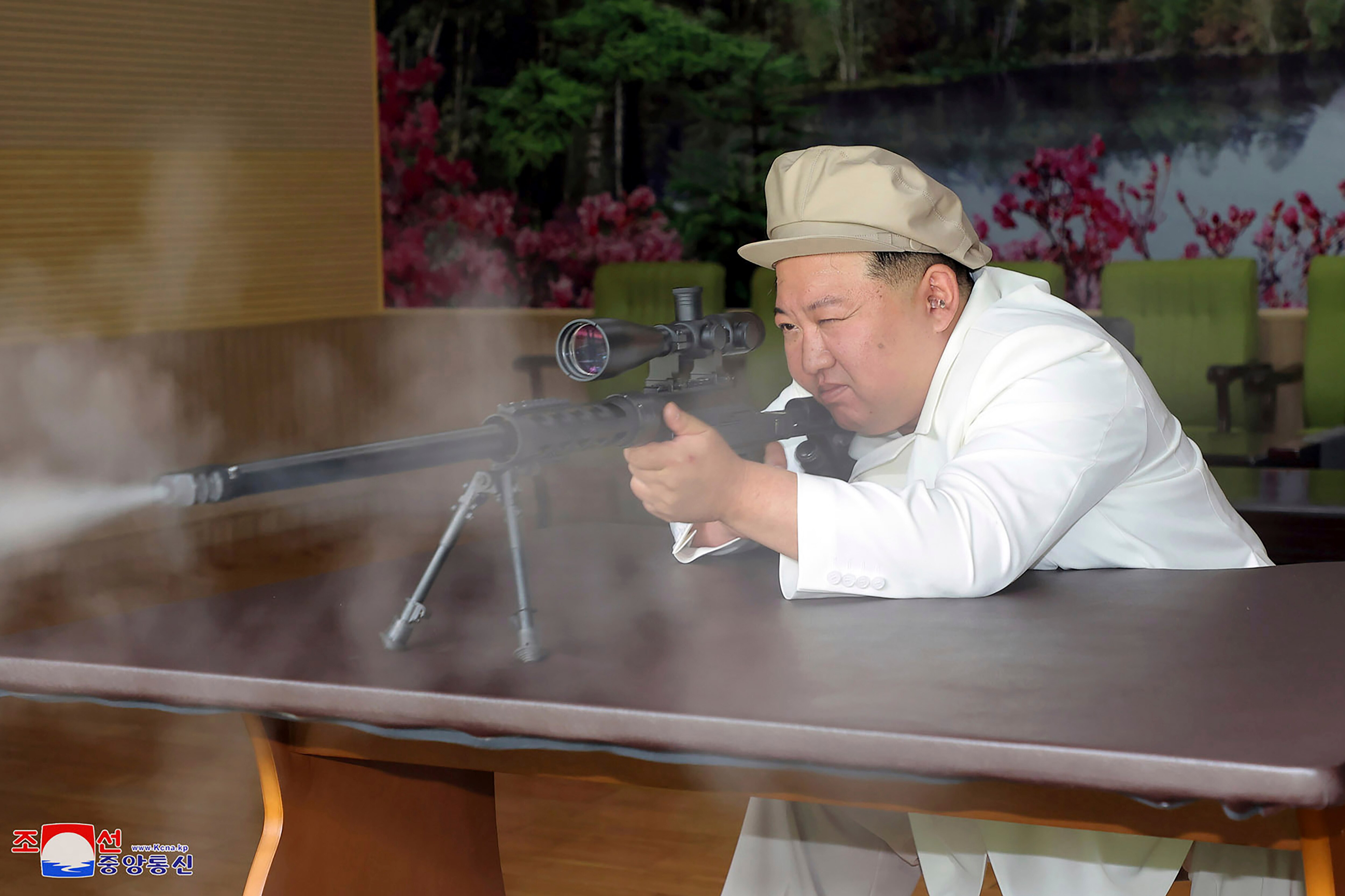 North Korean leader Kim Jong Un fires a gun in a shooting range.