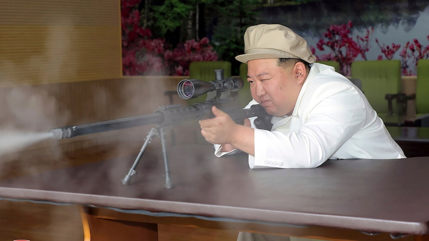 North Korean leader Kim Jong Un fires a gun in a shooting range.