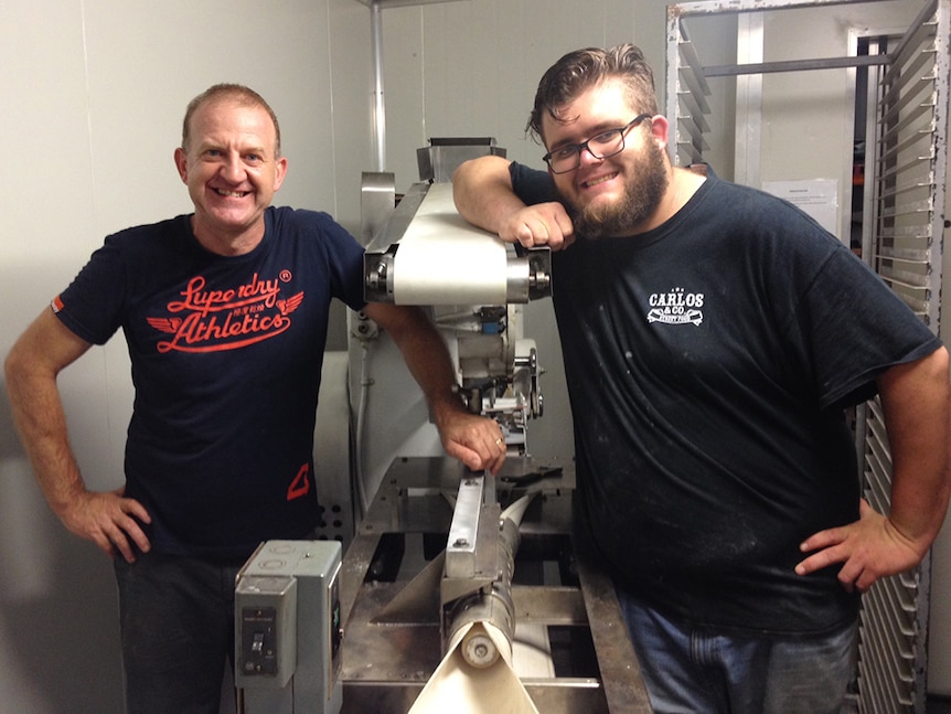 Steve McGuinness and Chuck Edwards with the bagel machine.