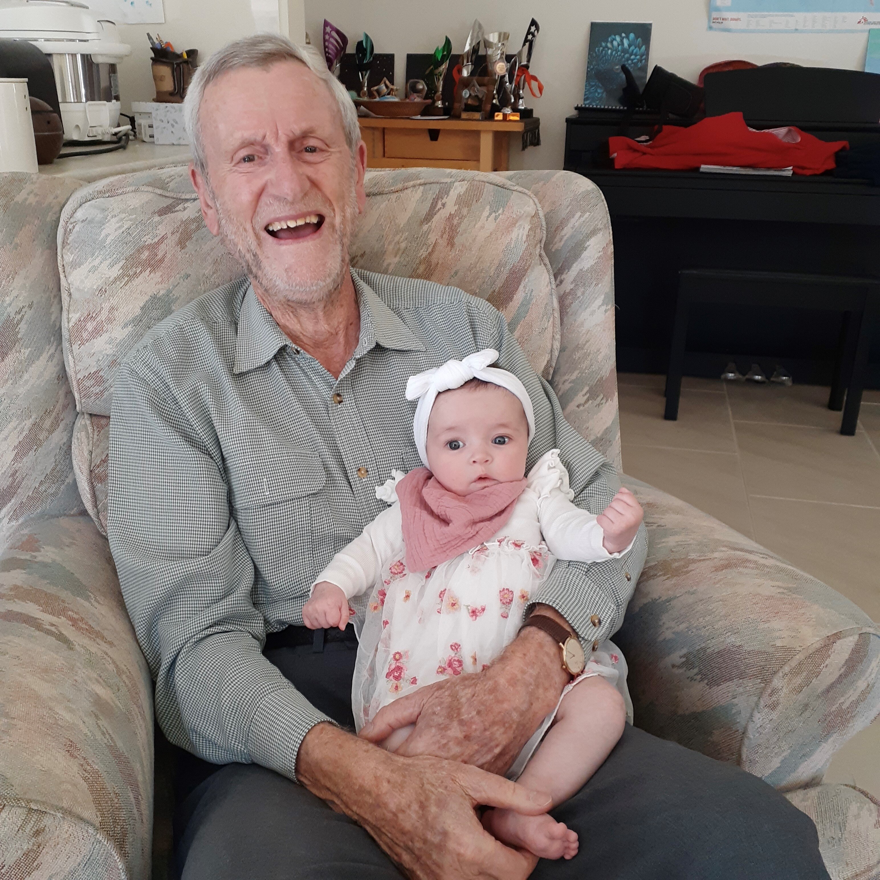 Reverend David Curtis holding his grand daughter